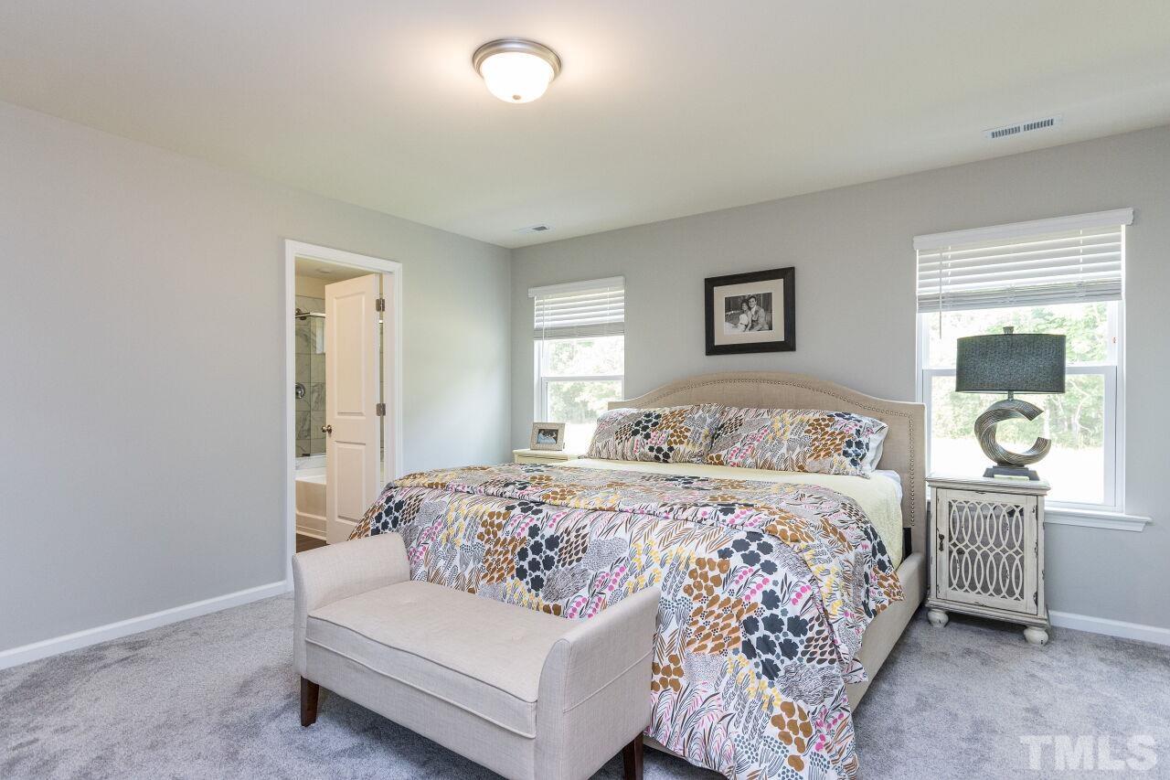 1109 Sandtrap Way Durham, NC 27703 - Photo 13 of 35 a bedroom with a large bed and a window