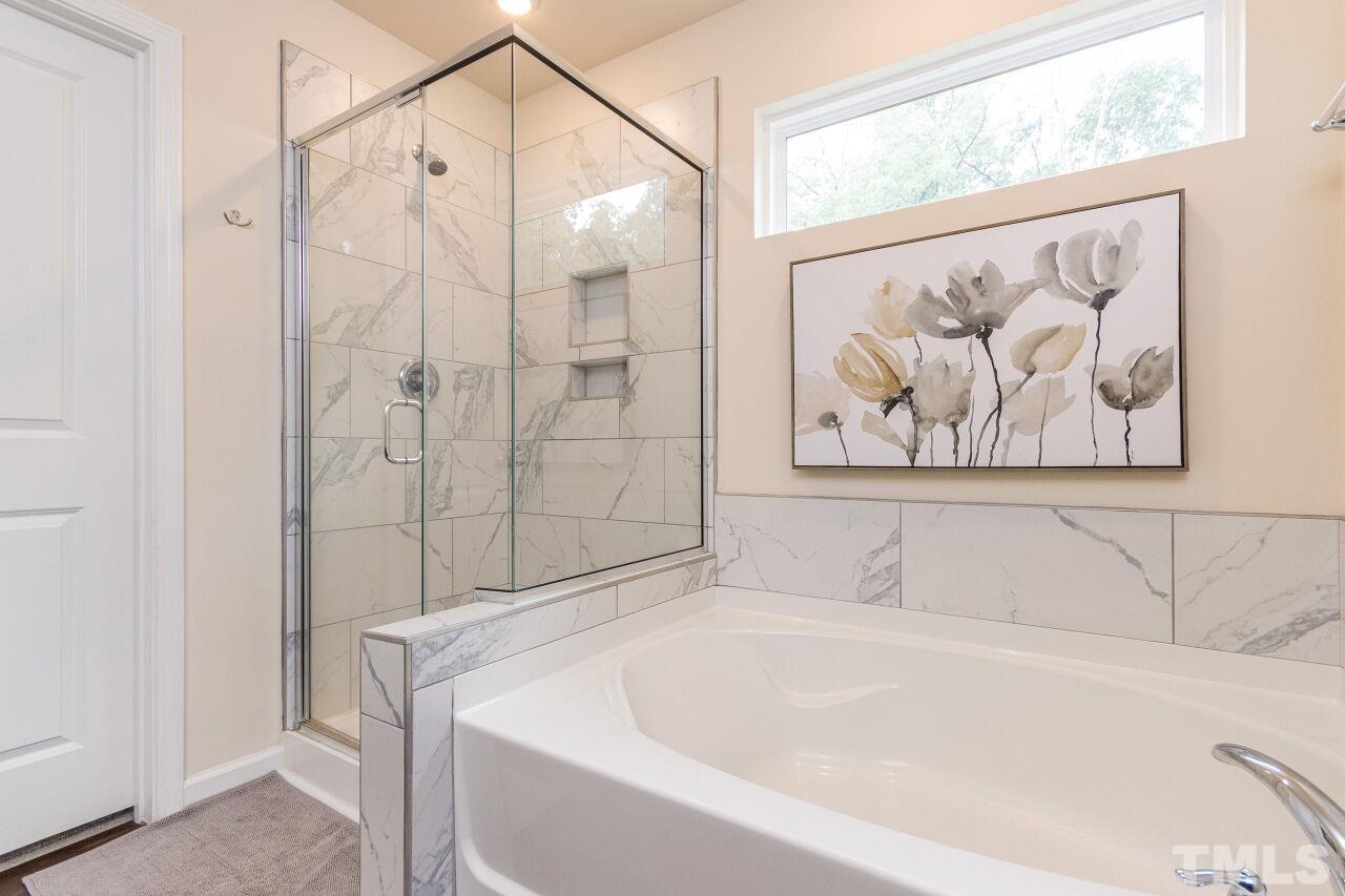 1109 Sandtrap Way Durham, NC 27703 - Photo 15 of 35 a white bath tub sitting next to a shower