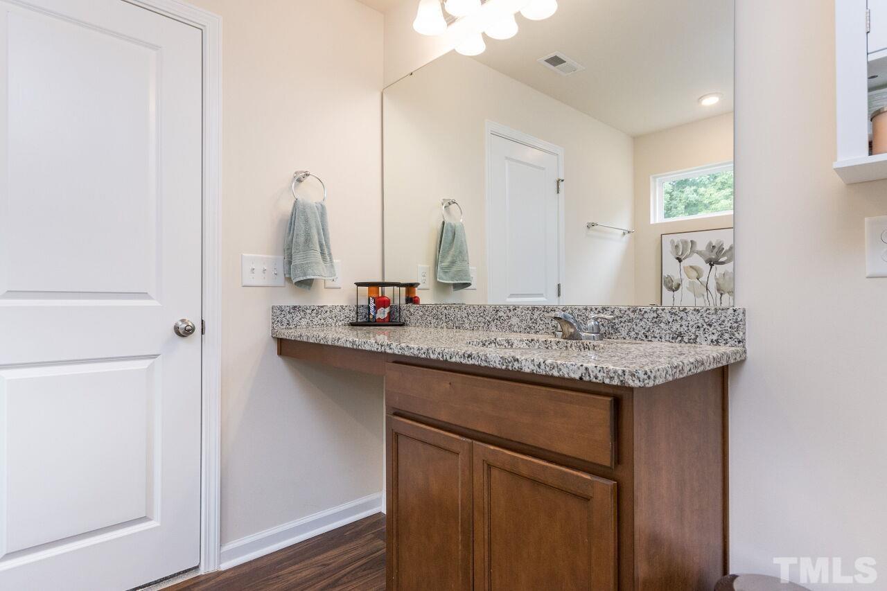 1109 Sandtrap Way Durham, NC 27703 - Photo 16 of 35 a bathroom with a granite countertop sink and a mirror