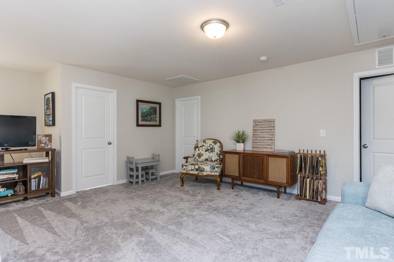 1109 Sandtrap Way Durham, NC 27703 - Photo 18 of 35 a living room with furniture and a flat screen tv