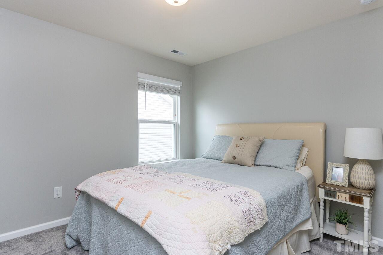 1109 Sandtrap Way Durham, NC 27703 - Photo 21 of 35 a bedroom with a bed and a window