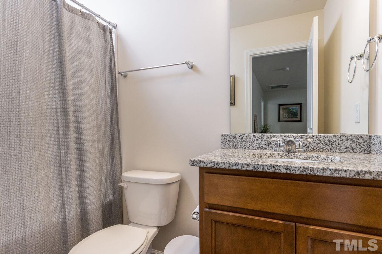 1109 Sandtrap Way Durham, NC 27703 - Photo 22 of 35 a bathroom with a granite countertop sink and a toilet