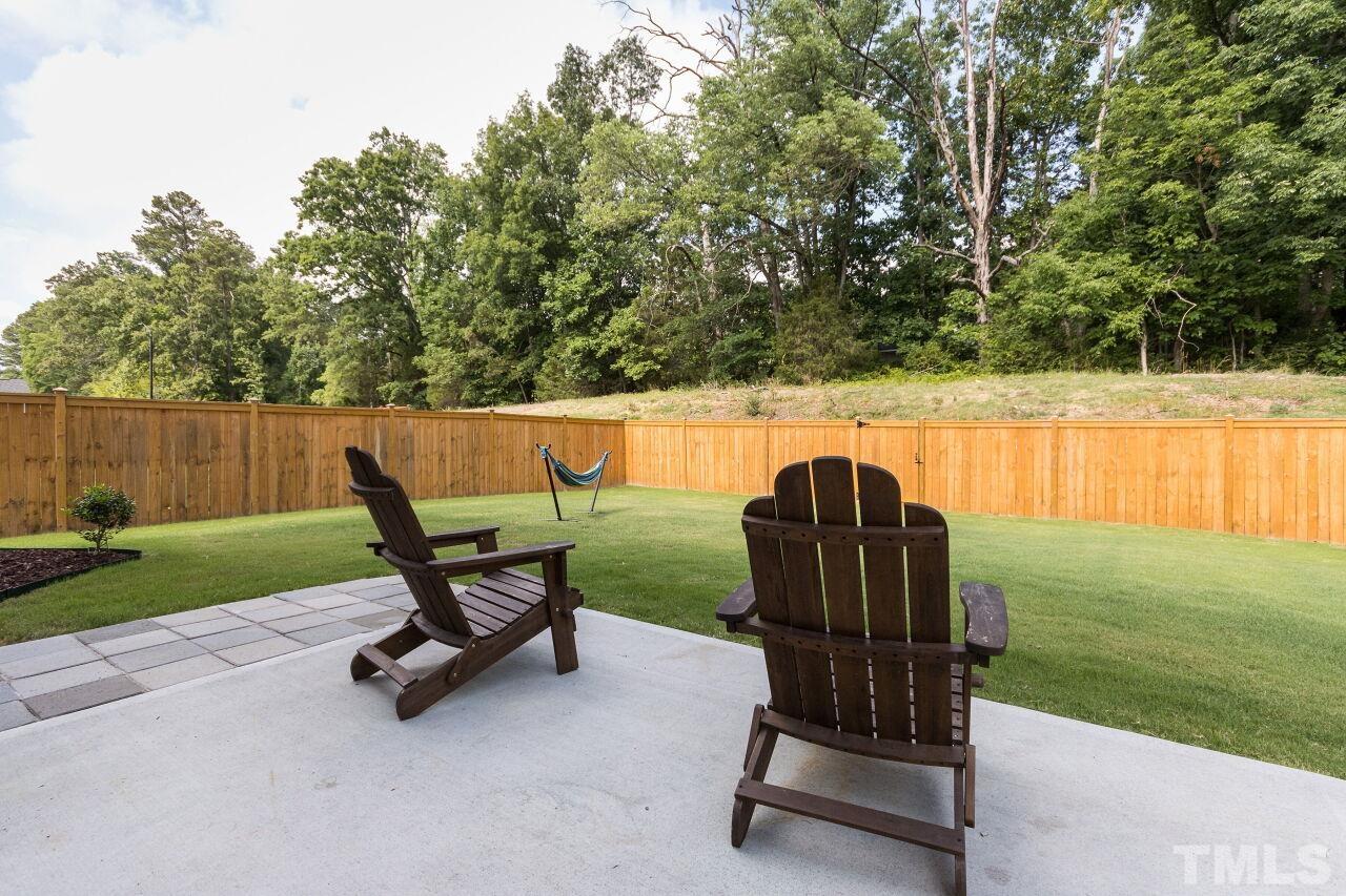 1109 Sandtrap Way Durham, NC 27703 - Photo 23 of 35 a wooden bench sitting in the middle of a park with a bench and trees