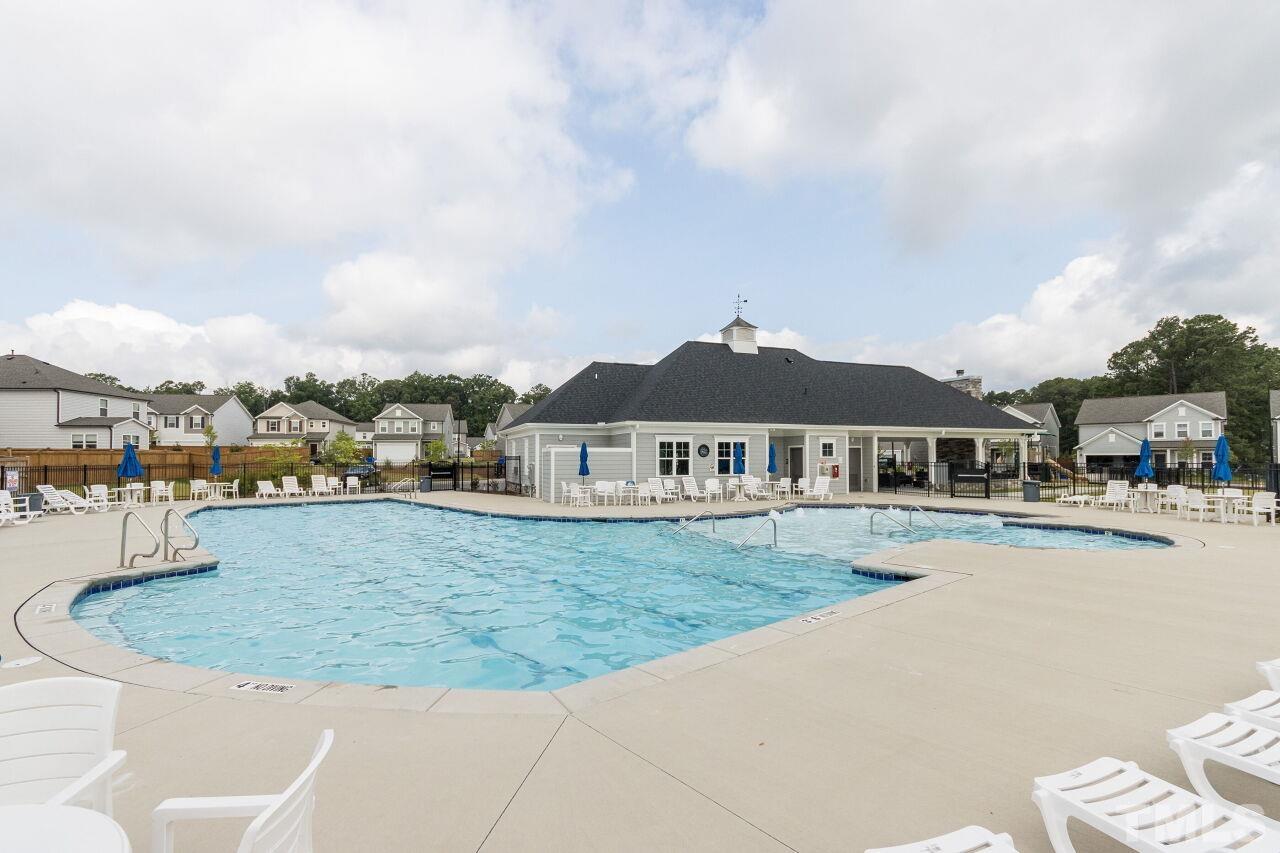 1109 Sandtrap Way Durham, NC 27703 - Photo 28 of 35 a view of a house with swimming pool and a yard