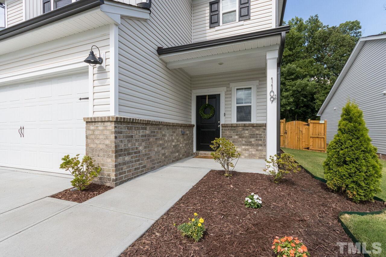 1109 Sandtrap Way Durham, NC 27703 - Photo 3 of 35 a front view of a house with a yard