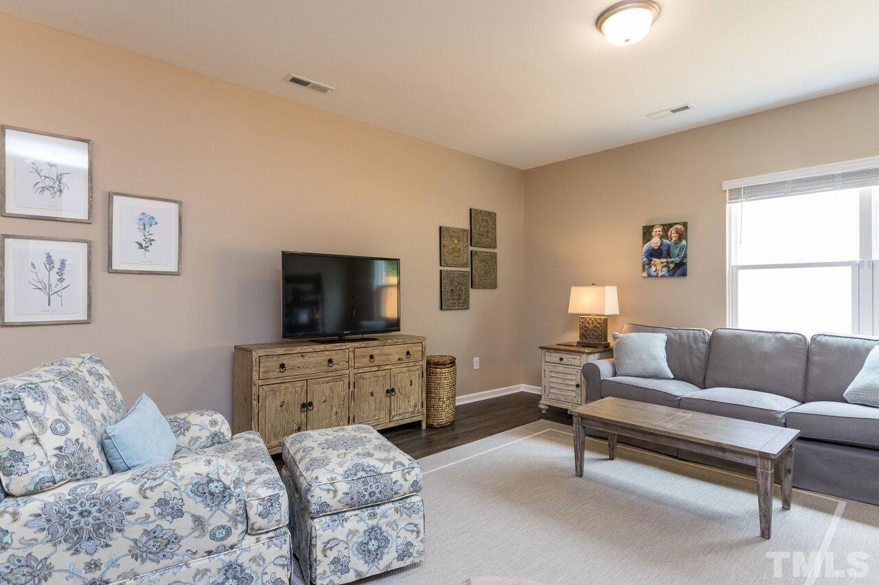 1109 Sandtrap Way Durham, NC 27703 - Photo 6 of 35 a living room with furniture and a flat screen tv