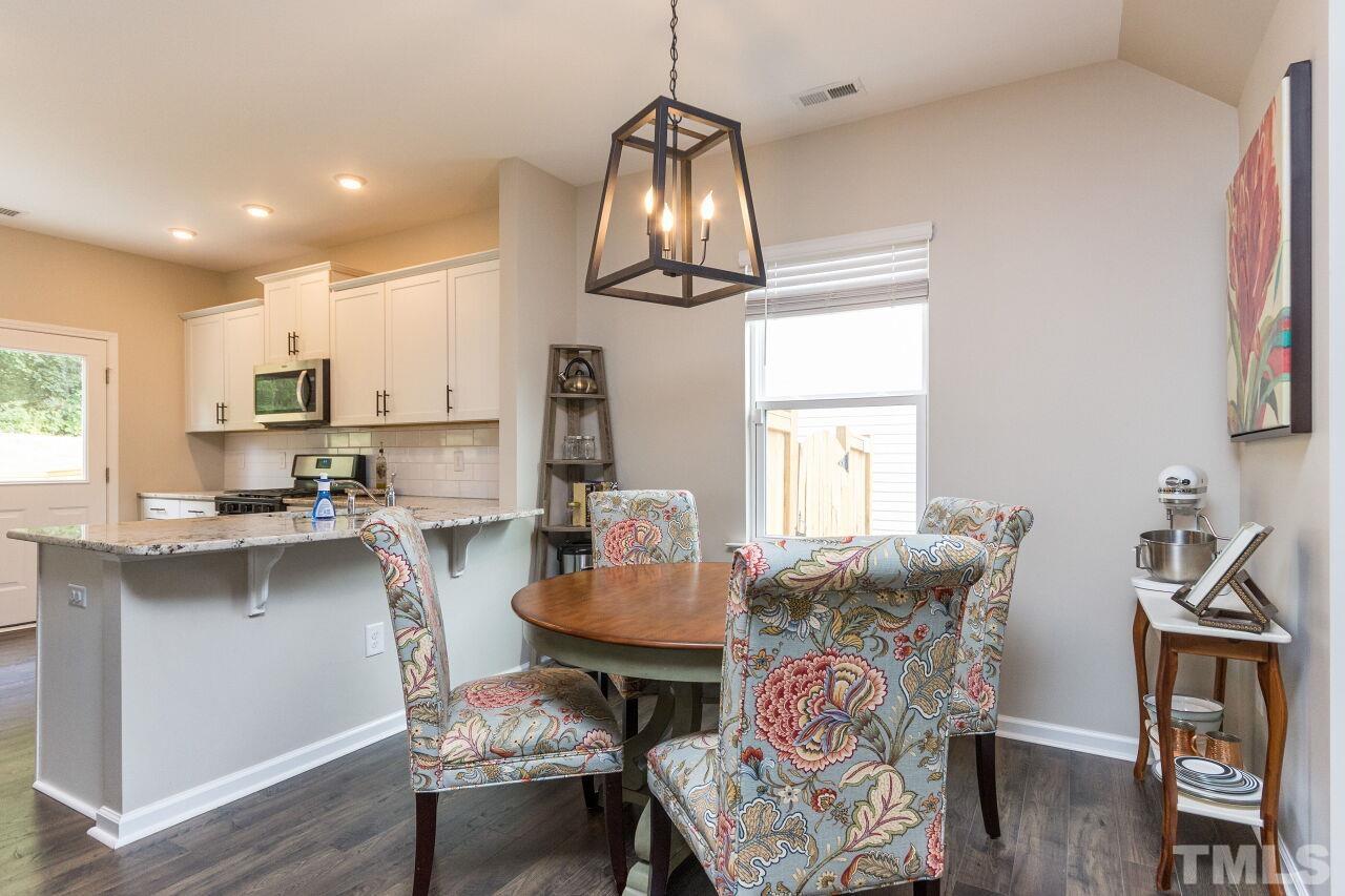 1109 Sandtrap Way Durham, NC 27703 - Photo 8 of 35 a view of a dining room with furniture window and wooden floor
