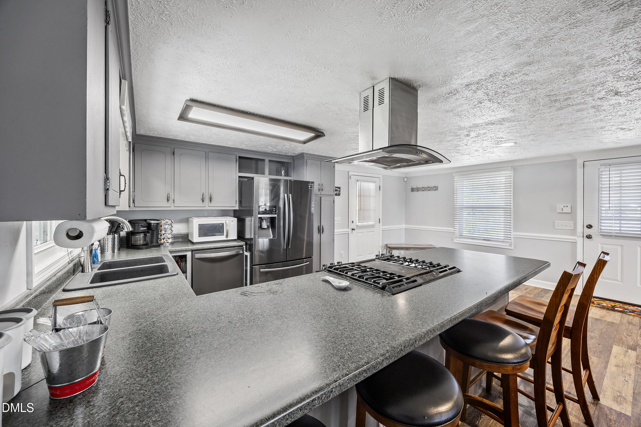 8056 Concord Church Road Autryville, NC 28318 - Photo 11 of 48 a kitchen with granite countertop a table chairs stove and cabinets