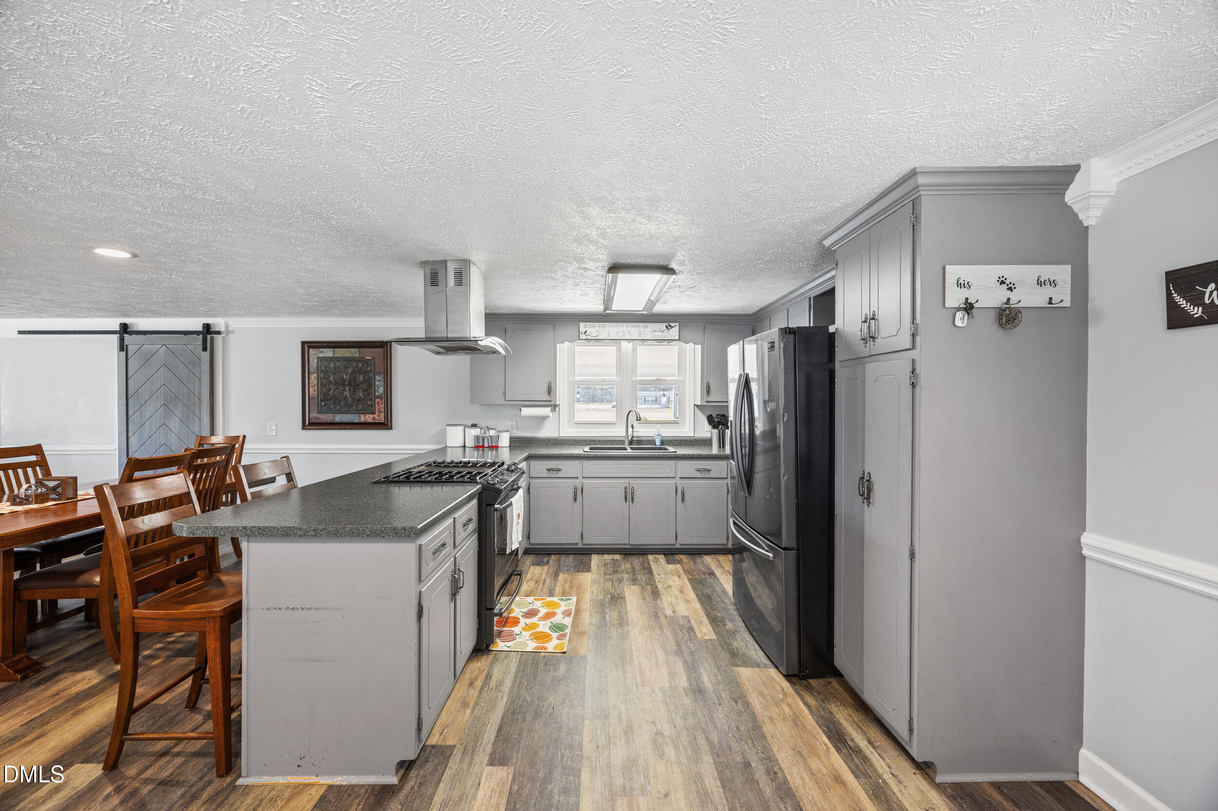 8056 Concord Church Road Autryville, NC 28318 - Photo 12 of 48 a kitchen with refrigerator cabinets and wooden floor
