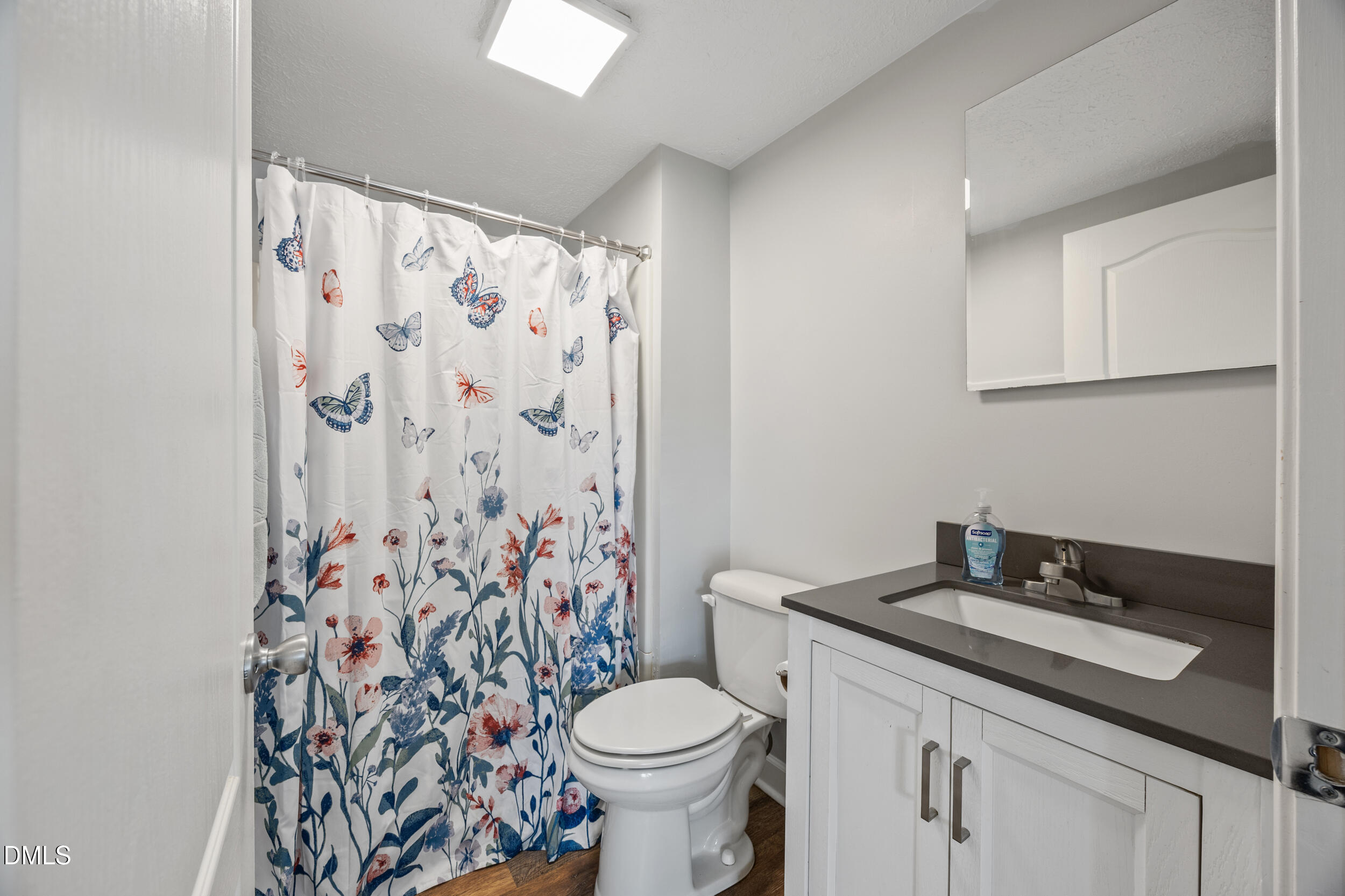 8056 Concord Church Road Autryville, NC 28318 - Photo 16 of 48 a bathroom with a granite countertop toilet sink and mirror