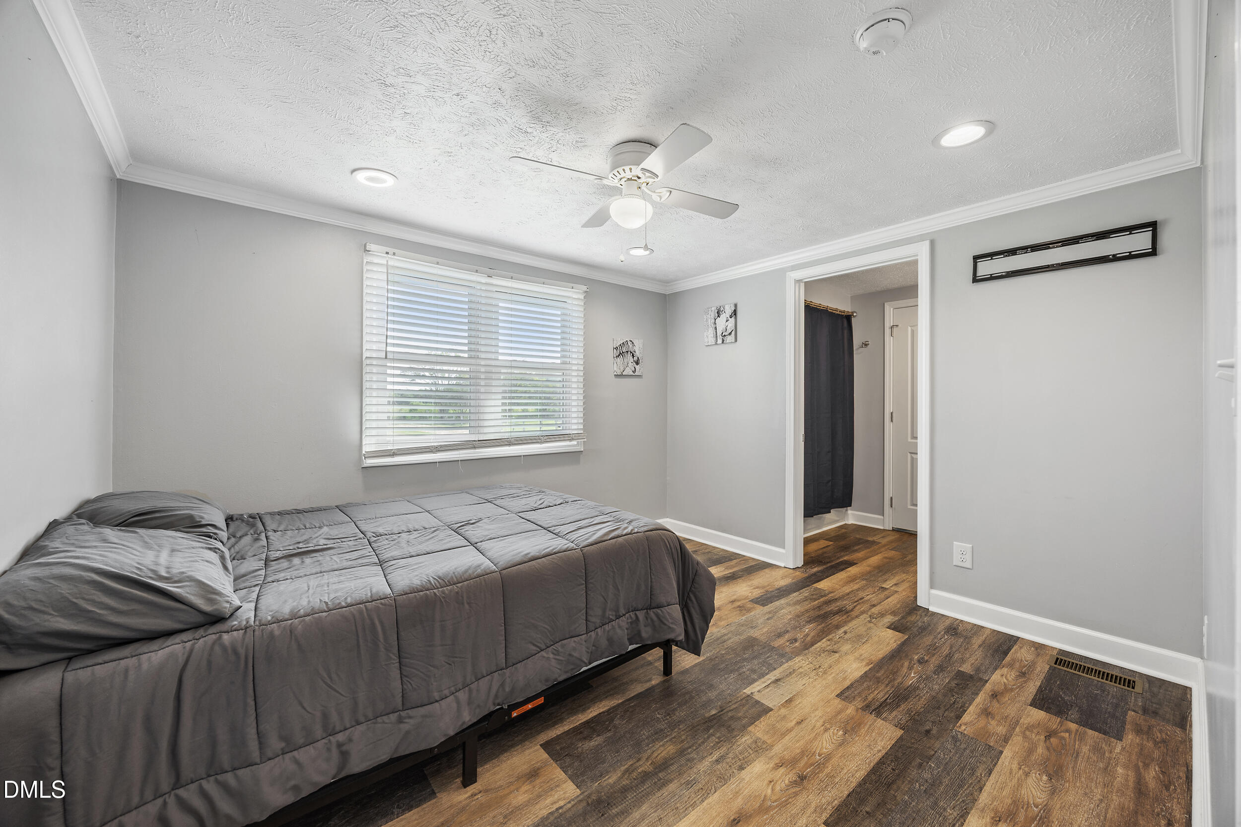 8056 Concord Church Road Autryville, NC 28318 - Photo 17 of 48 a bedroom with a bed and wooden floor