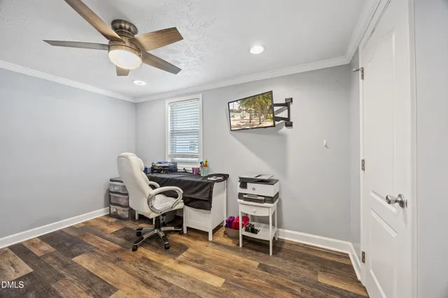 a view of a workspace with furniture and a window
