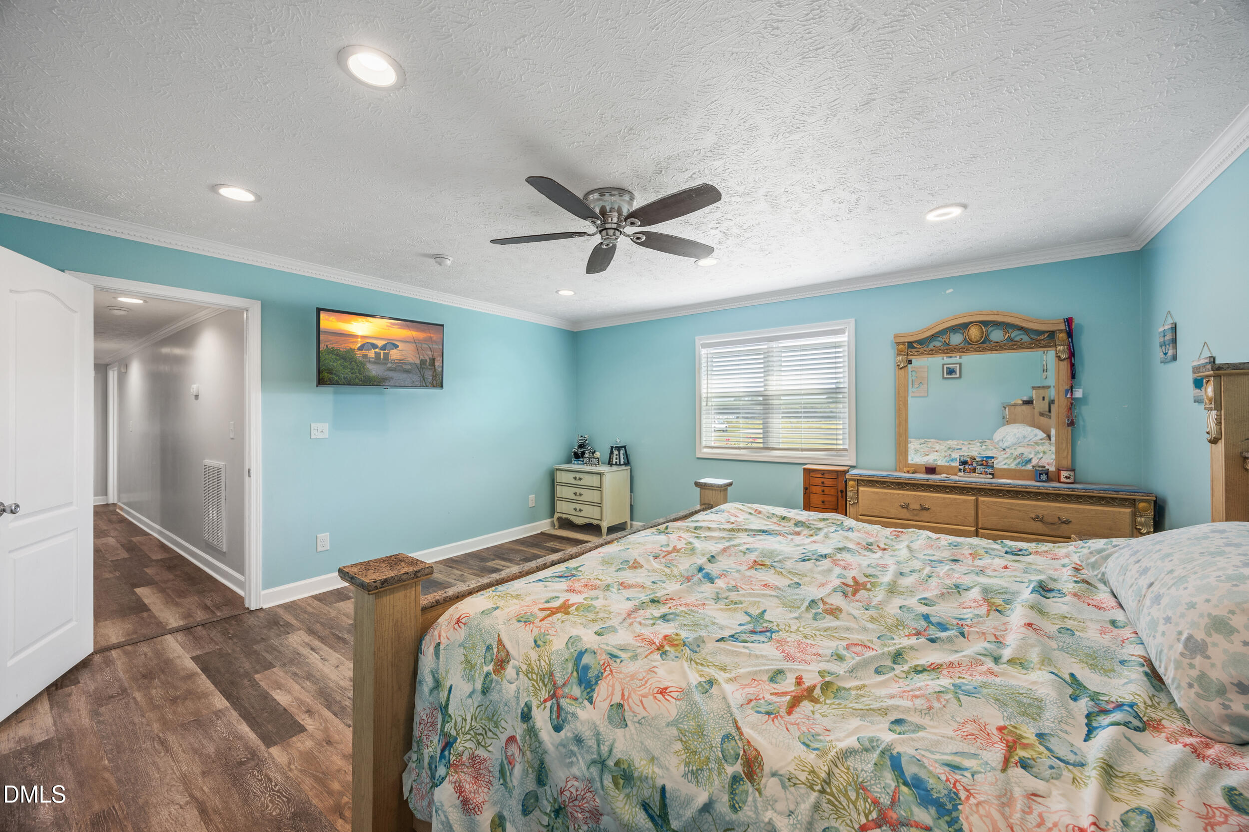 8056 Concord Church Road Autryville, NC 28318 - Photo 25 of 48 a bedroom with a large bed and a chandelier