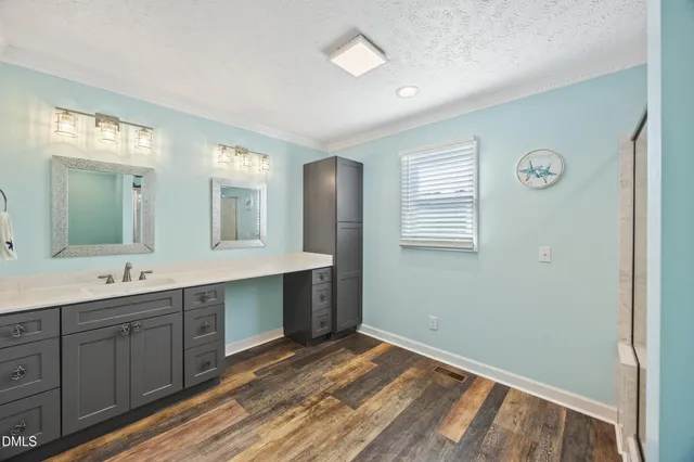 a spacious bathroom with a double vanity sink and a mirror