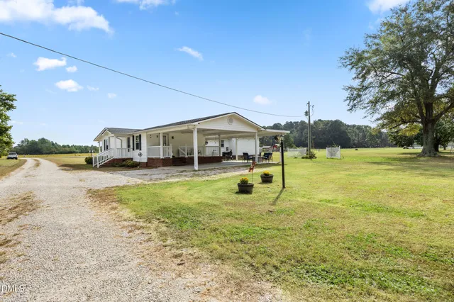 a swimming pool with outdoor seating and yard
