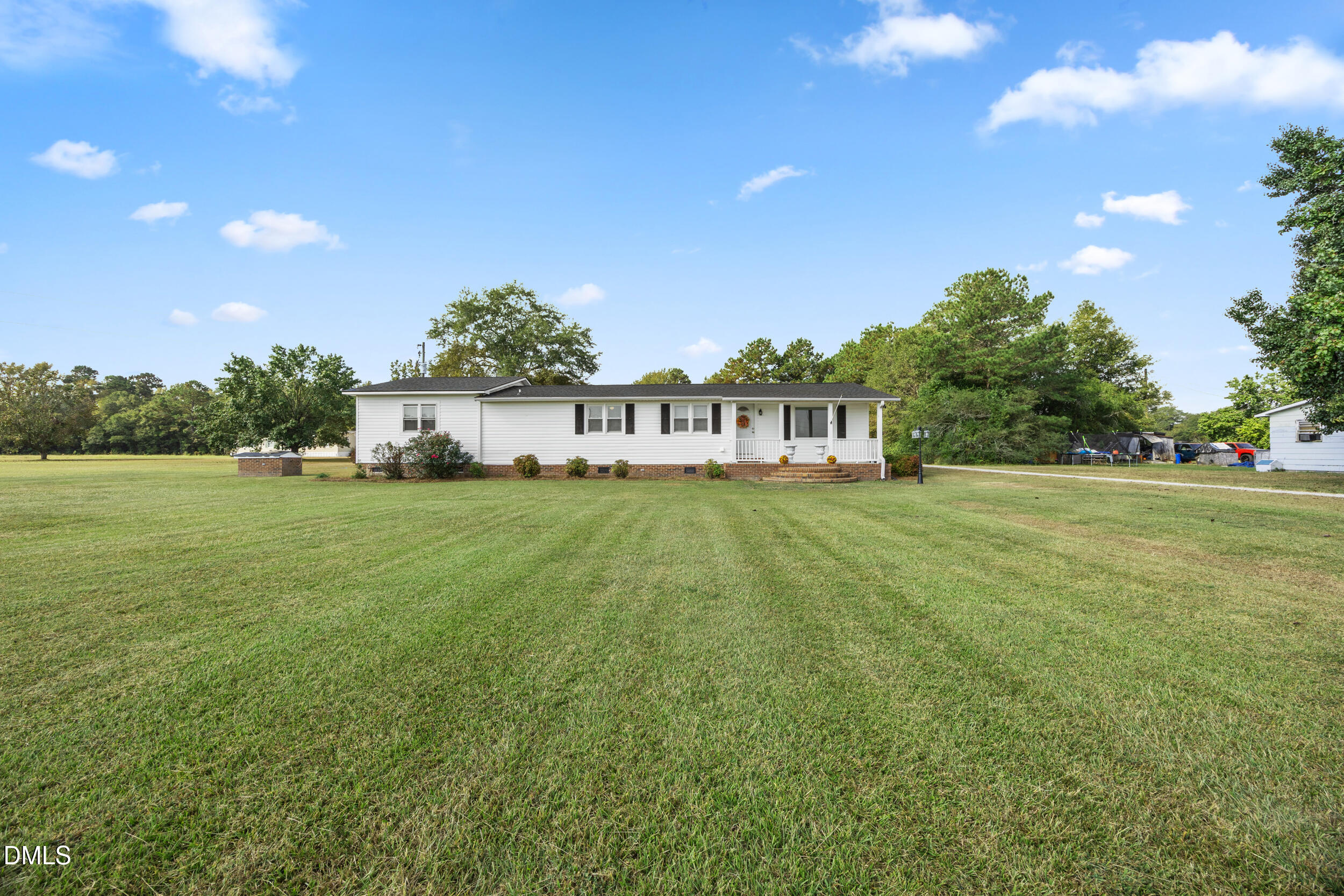 8056 Concord Church Road Autryville, NC 28318 - Photo 3 of 48 a view of house with garden space and car parked