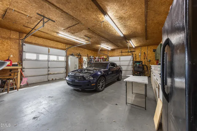 a view of garage with cars