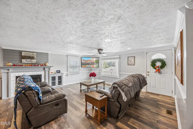 a living room with furniture and a wooden floor