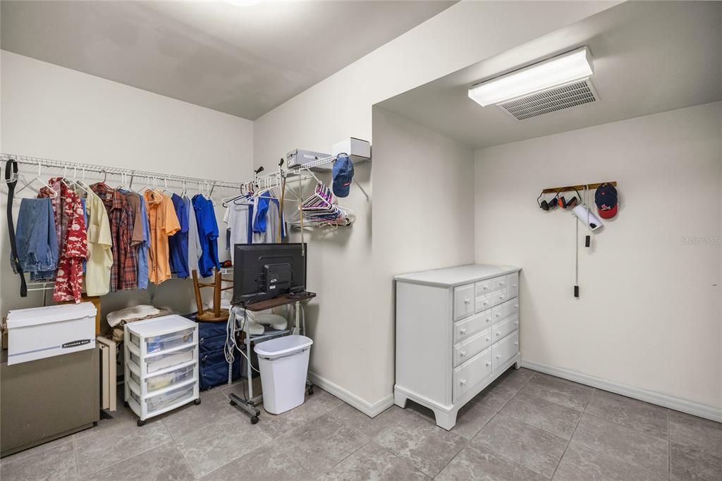 4559 West Dunklin Street Dunnellon, FL 34433 - Photo 17 of 65 a view of walk in closet with clothes and shoes