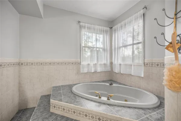 an empty room with a ceiling fan and carpet