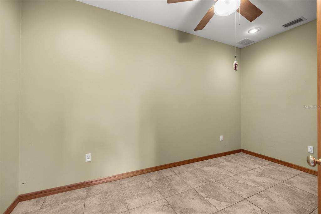4559 West Dunklin Street Dunnellon, FL 34433 - Photo 23 of 65 an empty room with a ceiling fan and carpet