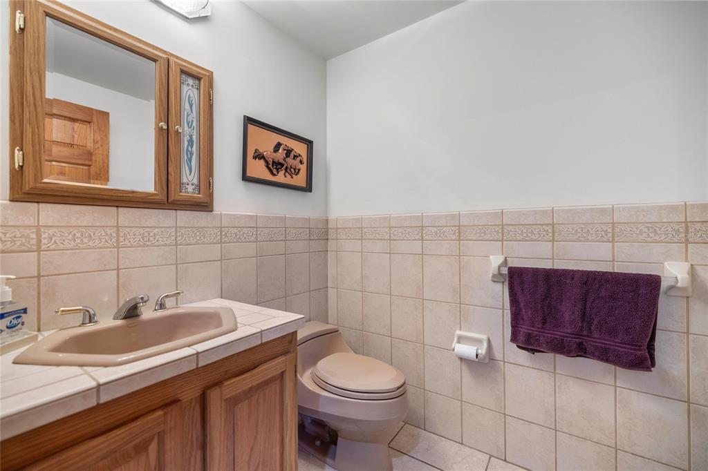 4559 West Dunklin Street Dunnellon, FL 34433 - Photo 26 of 65 a bathroom with a toilet sink and mirror