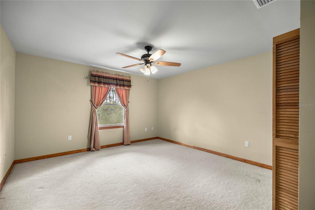 4559 West Dunklin Street Dunnellon, FL 34433 - Photo 27 of 65 an empty room with windows and fan