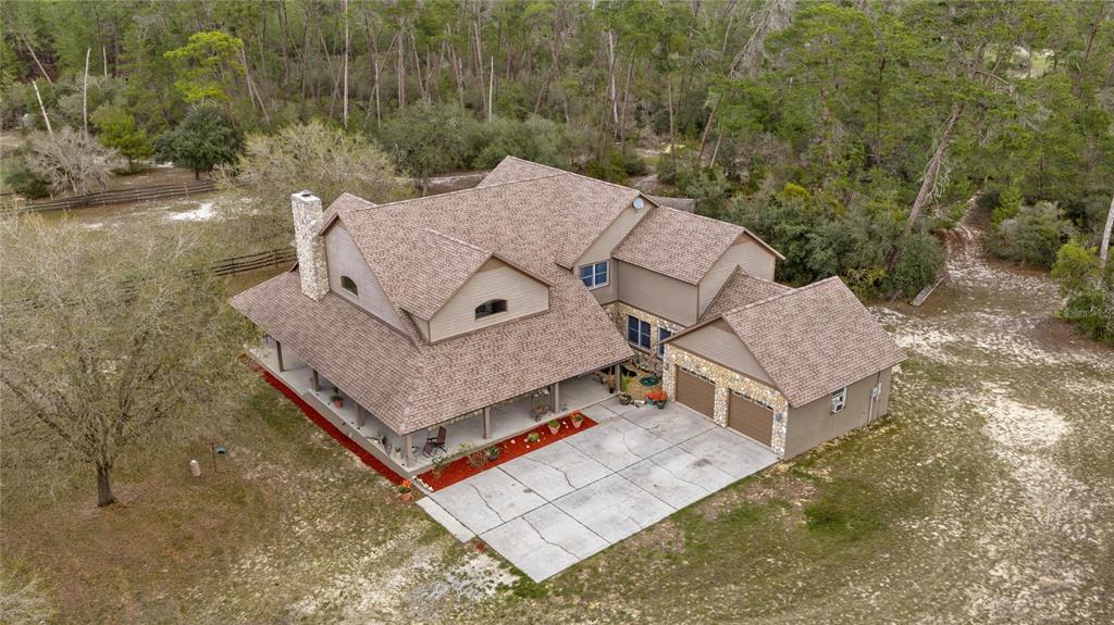 4559 West Dunklin Street Dunnellon, FL 34433 - Photo 3 of 65 an aerial view of a house with a yard and large tree