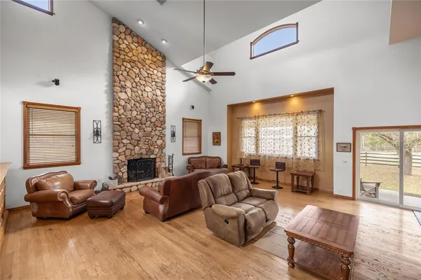 an aerial view of a house with a yard and large tree