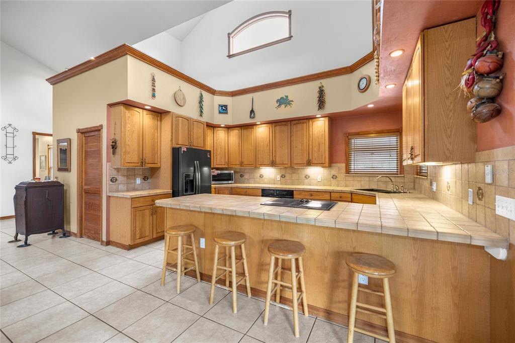 4559 West Dunklin Street Dunnellon, FL 34433 - Photo 37 of 65 a kitchen with stainless steel appliances granite countertop a stove a refrigerator and cabinets