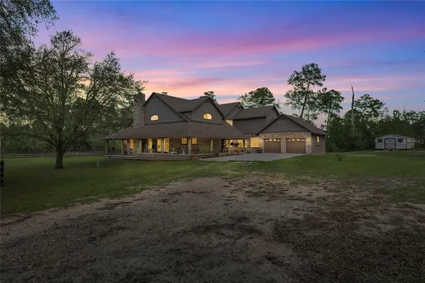 a front view of a house with swimming pool having outdoor seating