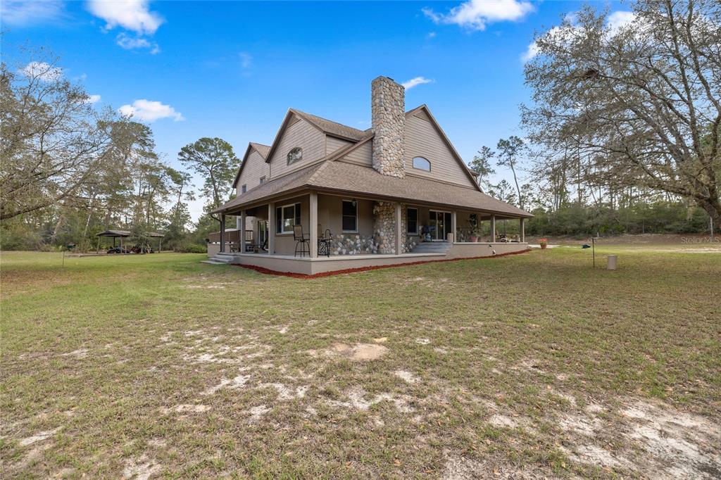 4559 West Dunklin Street Dunnellon, FL 34433 - Photo 44 of 65 a front view of a house with swimming pool having outdoor seating