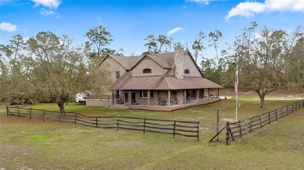 a front view of a house with swimming pool yard and a sitting area