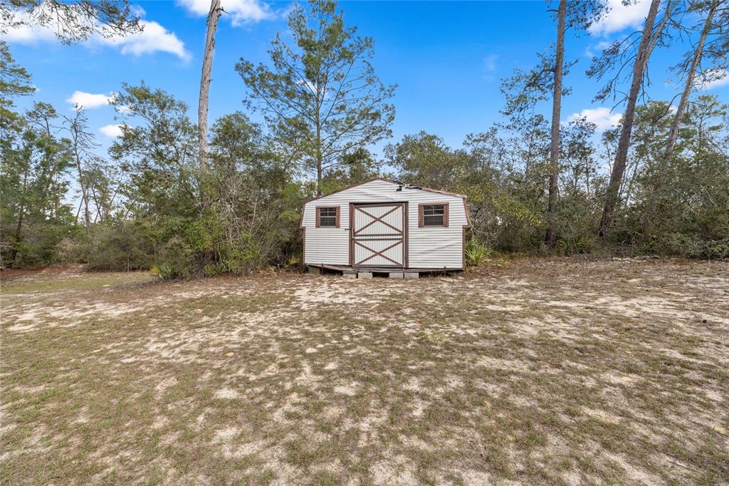 4559 West Dunklin Street Dunnellon, FL 34433 - Photo 59 of 65 a white house that has a tree in front of it