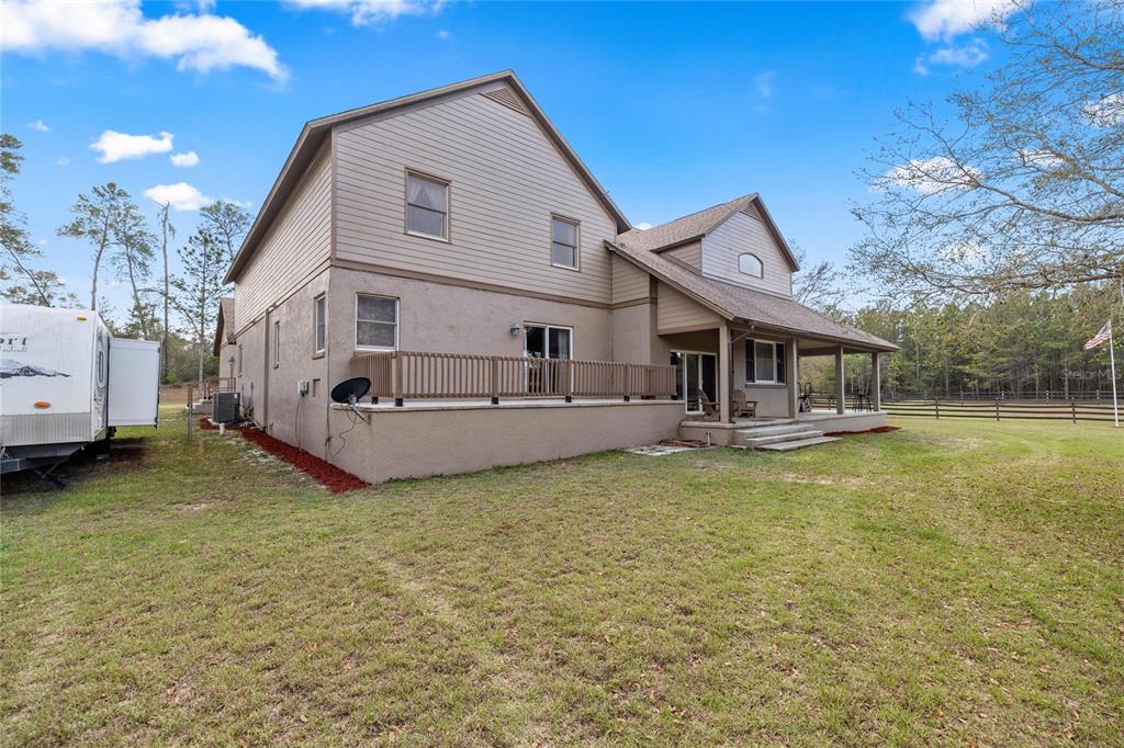 4559 West Dunklin Street Dunnellon, FL 34433 - Photo 60 of 65 a front view of a house with swimming pool yard and a sitting area