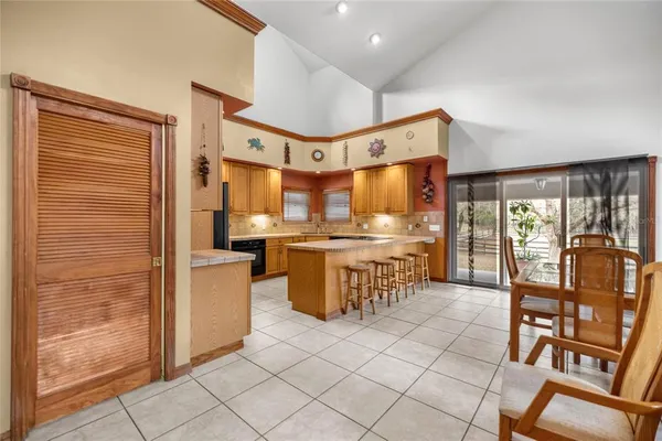 a kitchen with stainless steel appliances granite countertop a sink refrigerator and cabinets