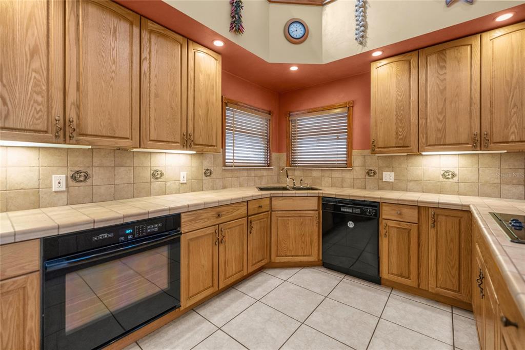 4559 West Dunklin Street Dunnellon, FL 34433 - Photo 7 of 65 a kitchen with stainless steel appliances granite countertop a sink stove and cabinets