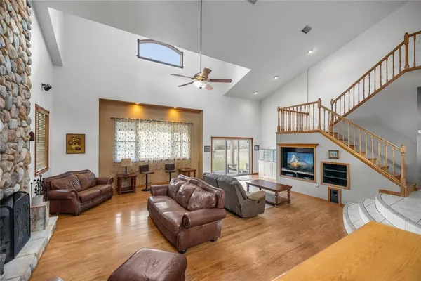 a living room with fireplace furniture and a wooden floor