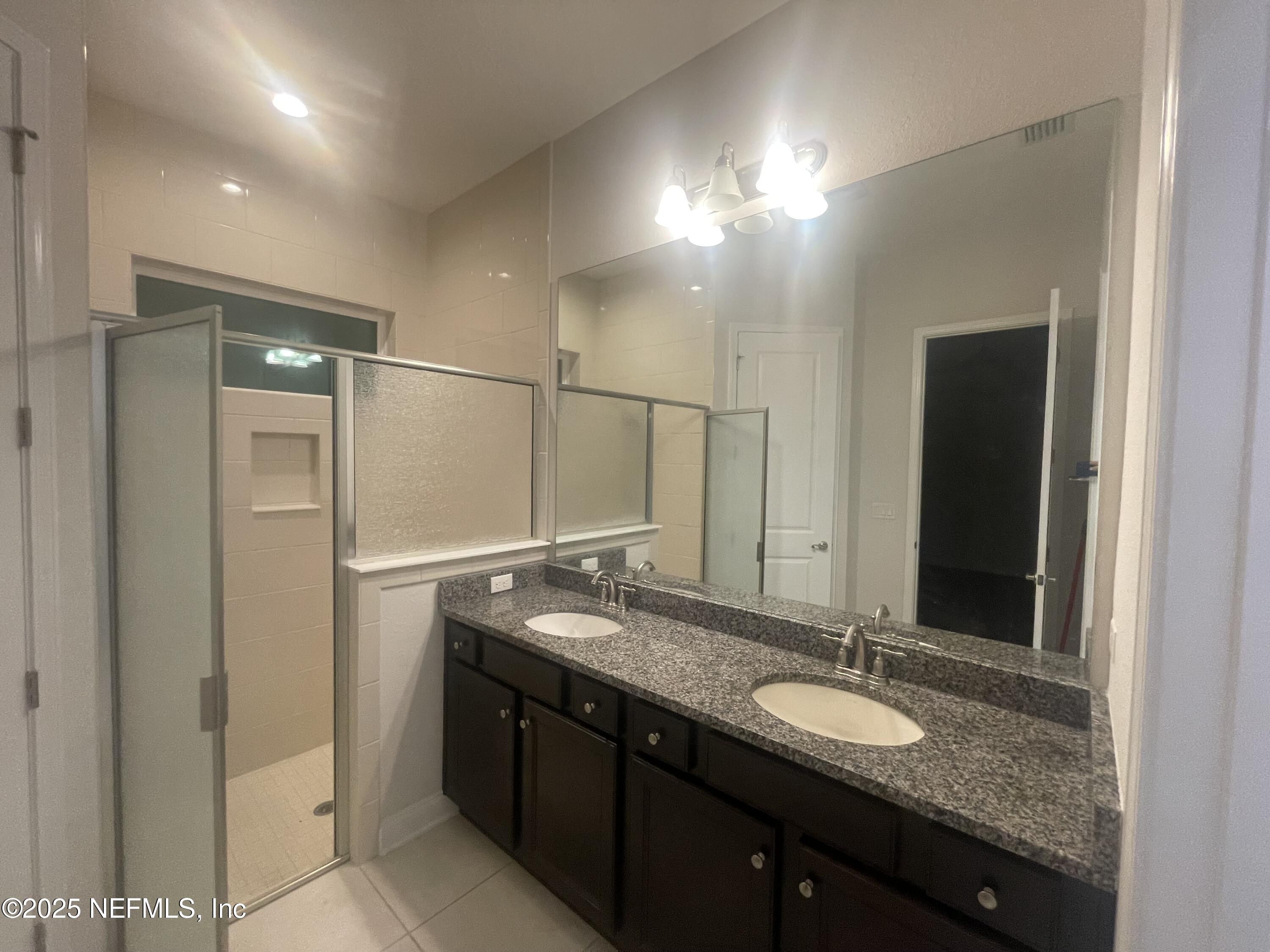 2489 Caprera Circle Jacksonville, FL 32246 - Photo 18 of 23 a bathroom with a granite countertop sink and a mirror