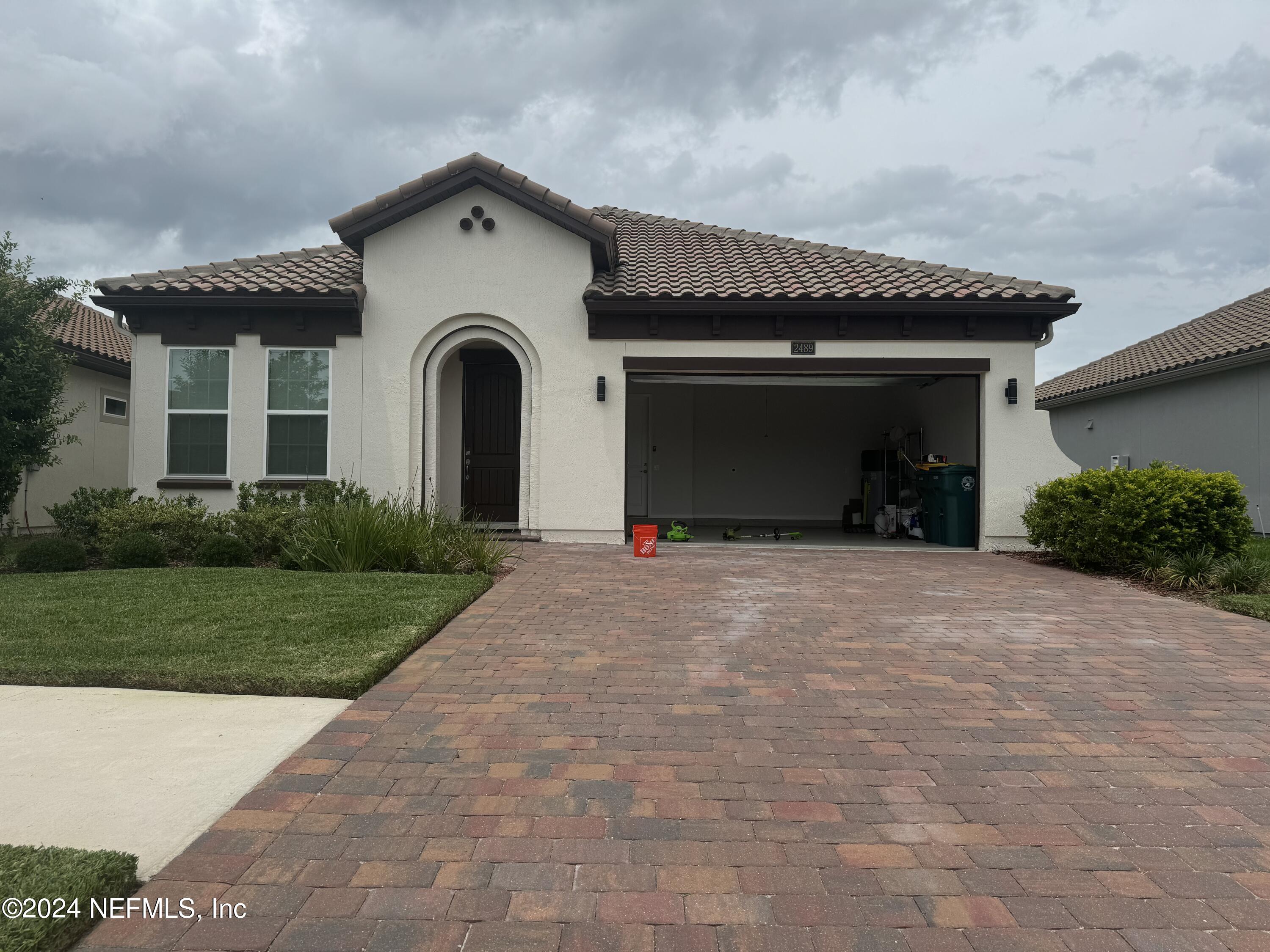 2489 Caprera Circle Jacksonville, FL 32246 - Photo 2 of 23 a front view of a house with a yard and garage