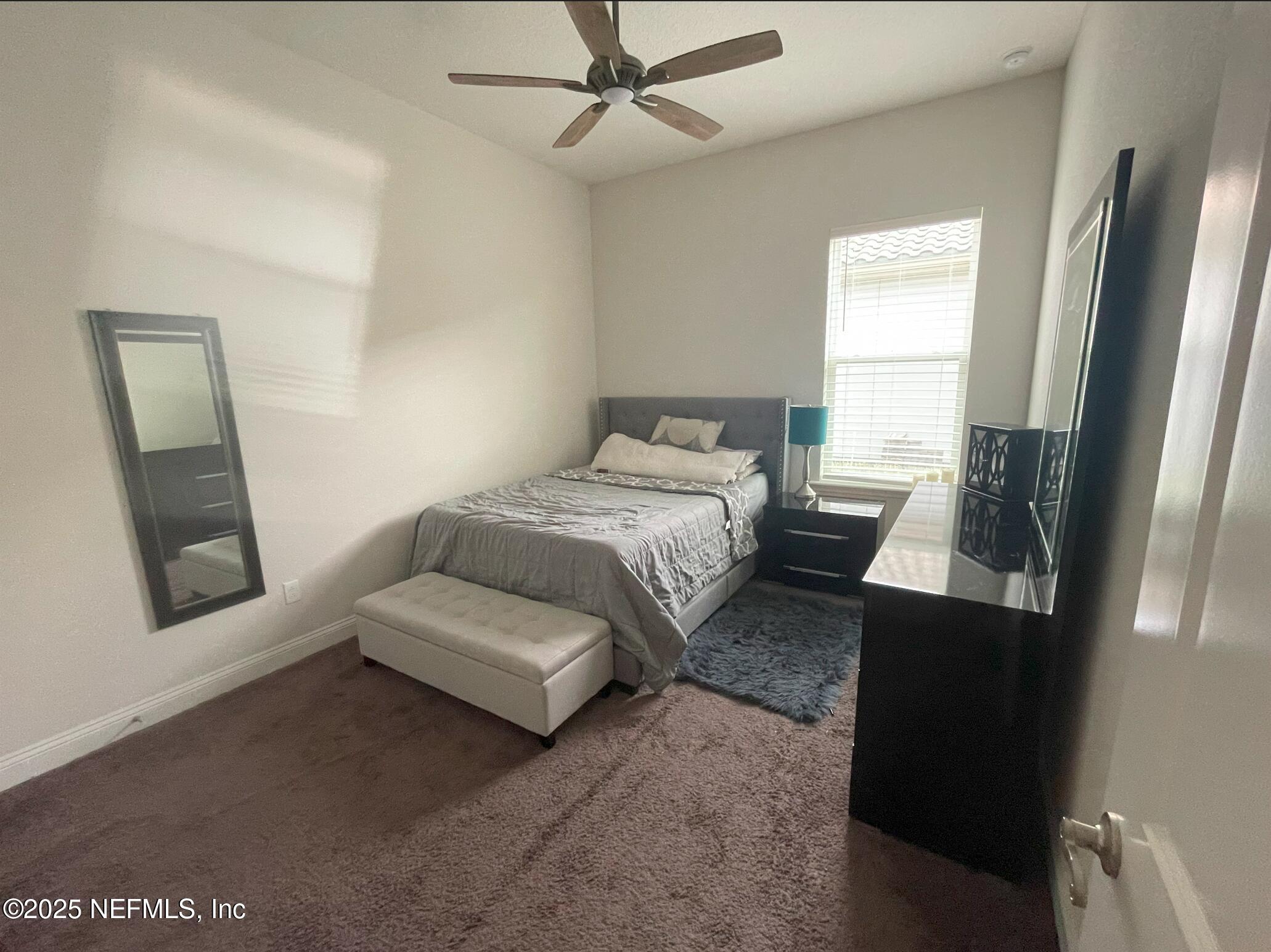 2489 Caprera Circle Jacksonville, FL 32246 - Photo 10 of 23 a bedroom with a bed and a mirror