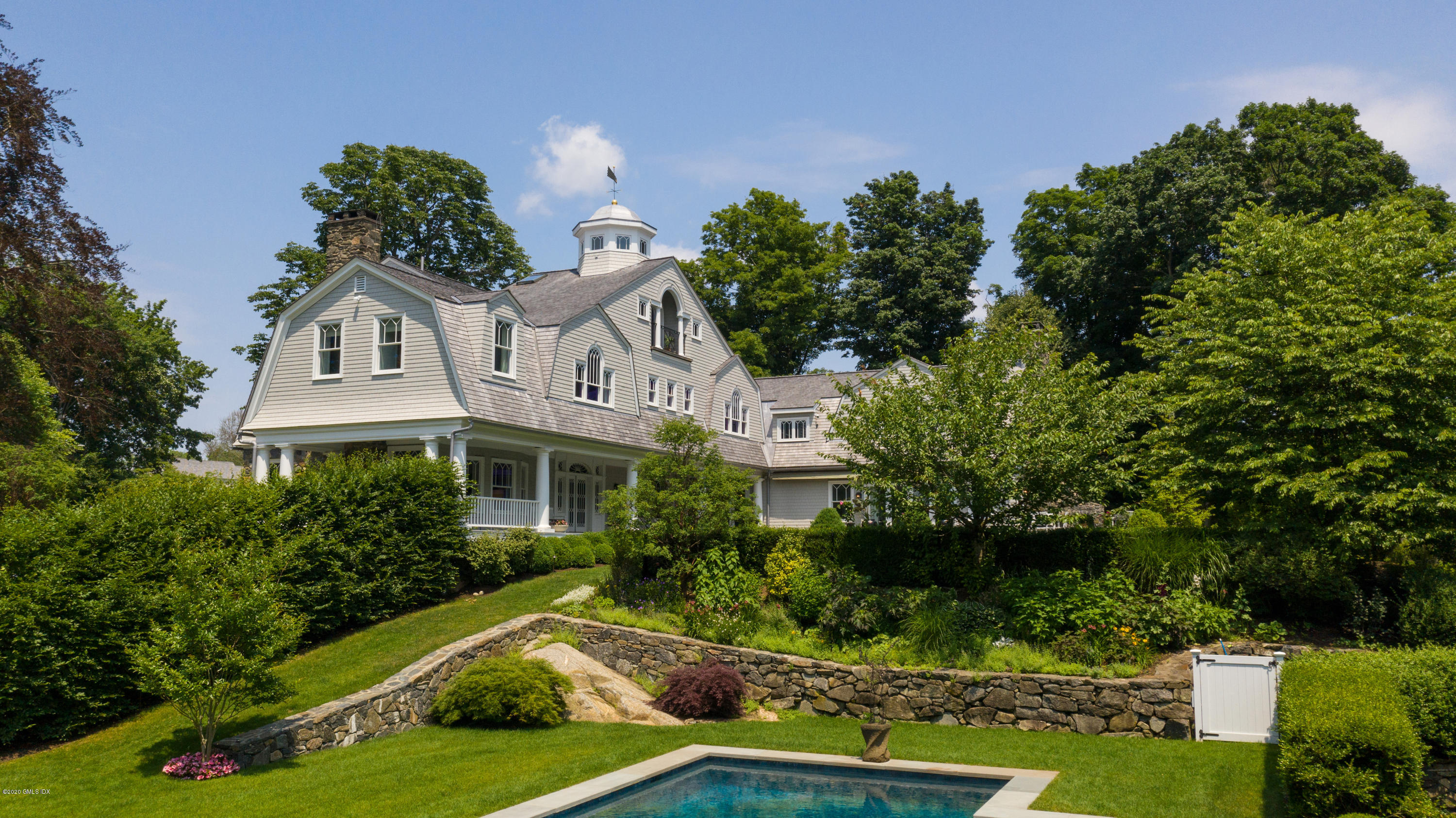 31 Rock Ridge Avenue Greenwich, CT 06831 - Photo 1 of 44 a front view of a house with a yard