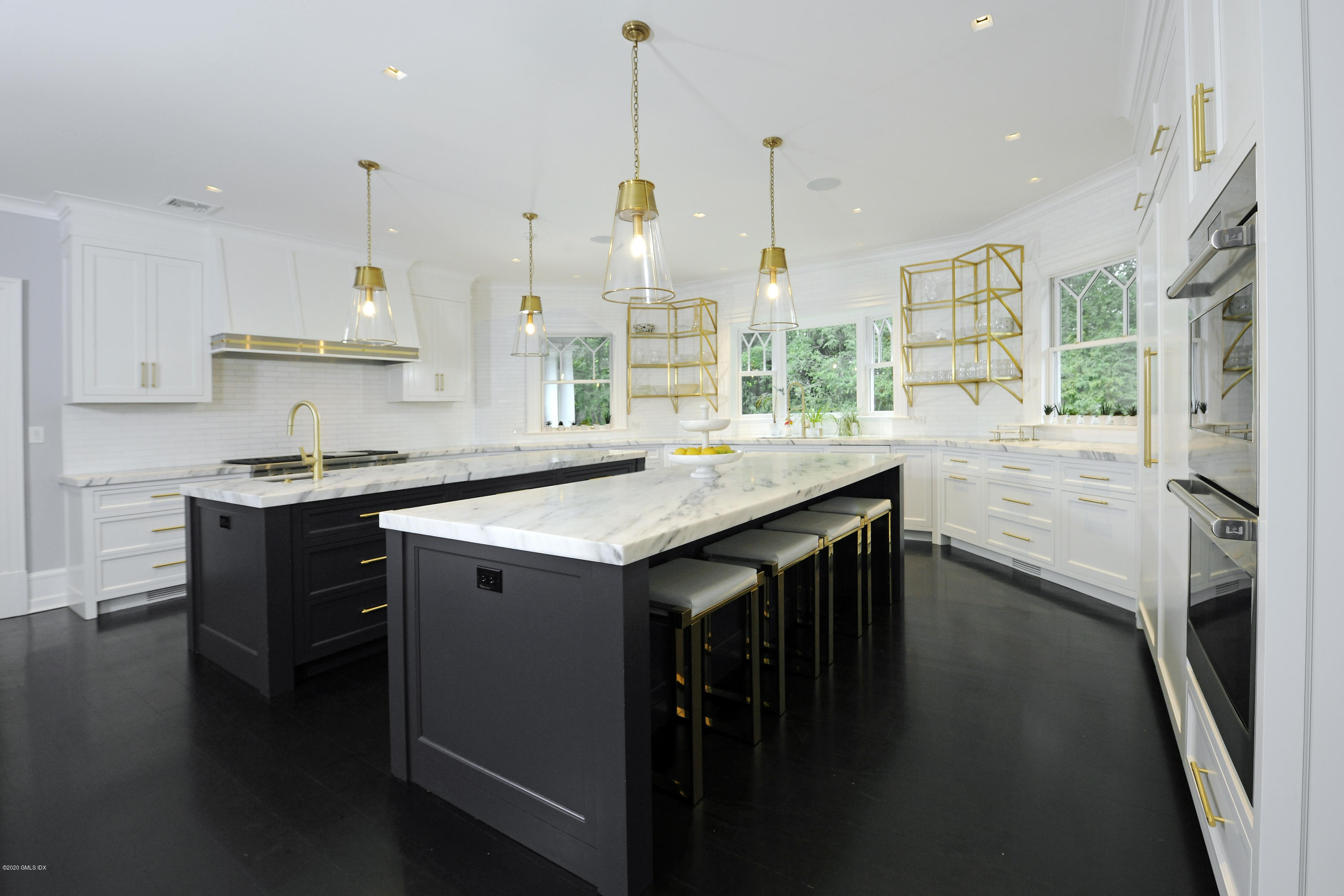 31 Rock Ridge Avenue Greenwich, CT 06831 - Photo 12 of 44 a kitchen with stainless steel appliances granite countertop a sink a stove and a wooden floors
