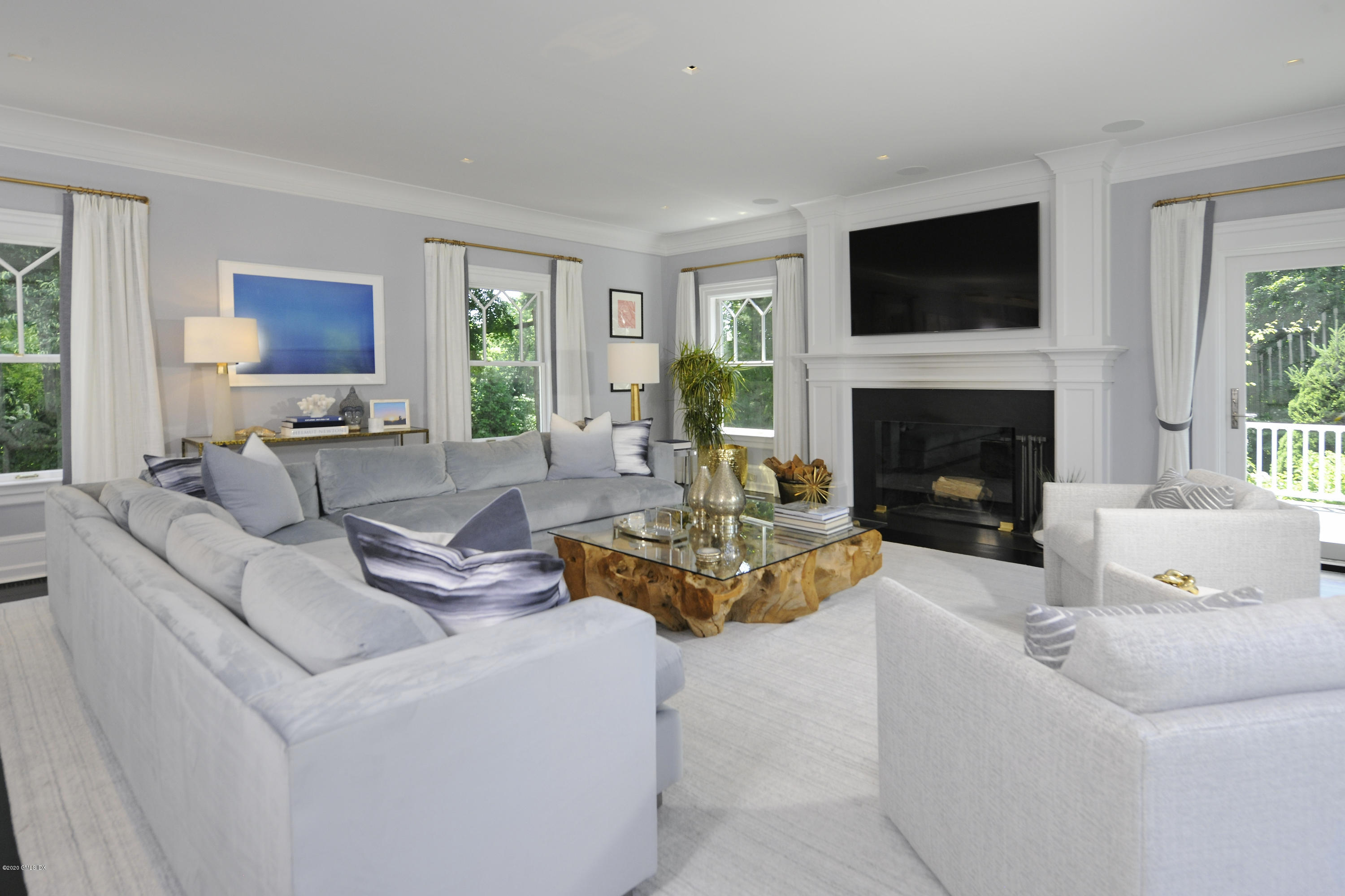 31 Rock Ridge Avenue Greenwich, CT 06831 - Photo 14 of 44 a living room with furniture a fireplace and a flat screen tv