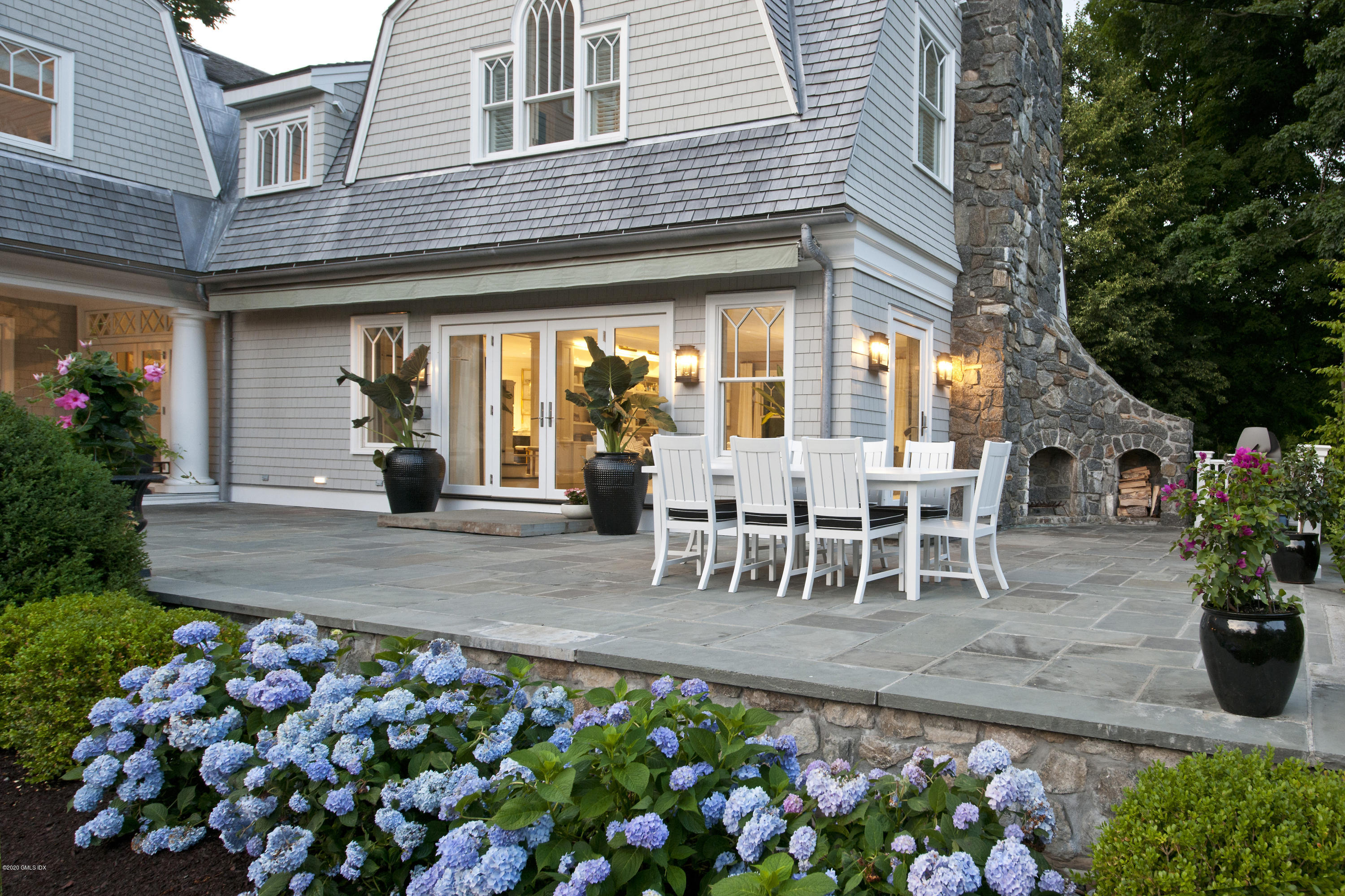 31 Rock Ridge Avenue Greenwich, CT 06831 - Photo 16 of 44 a view of a patio with table and chairs and potted plants