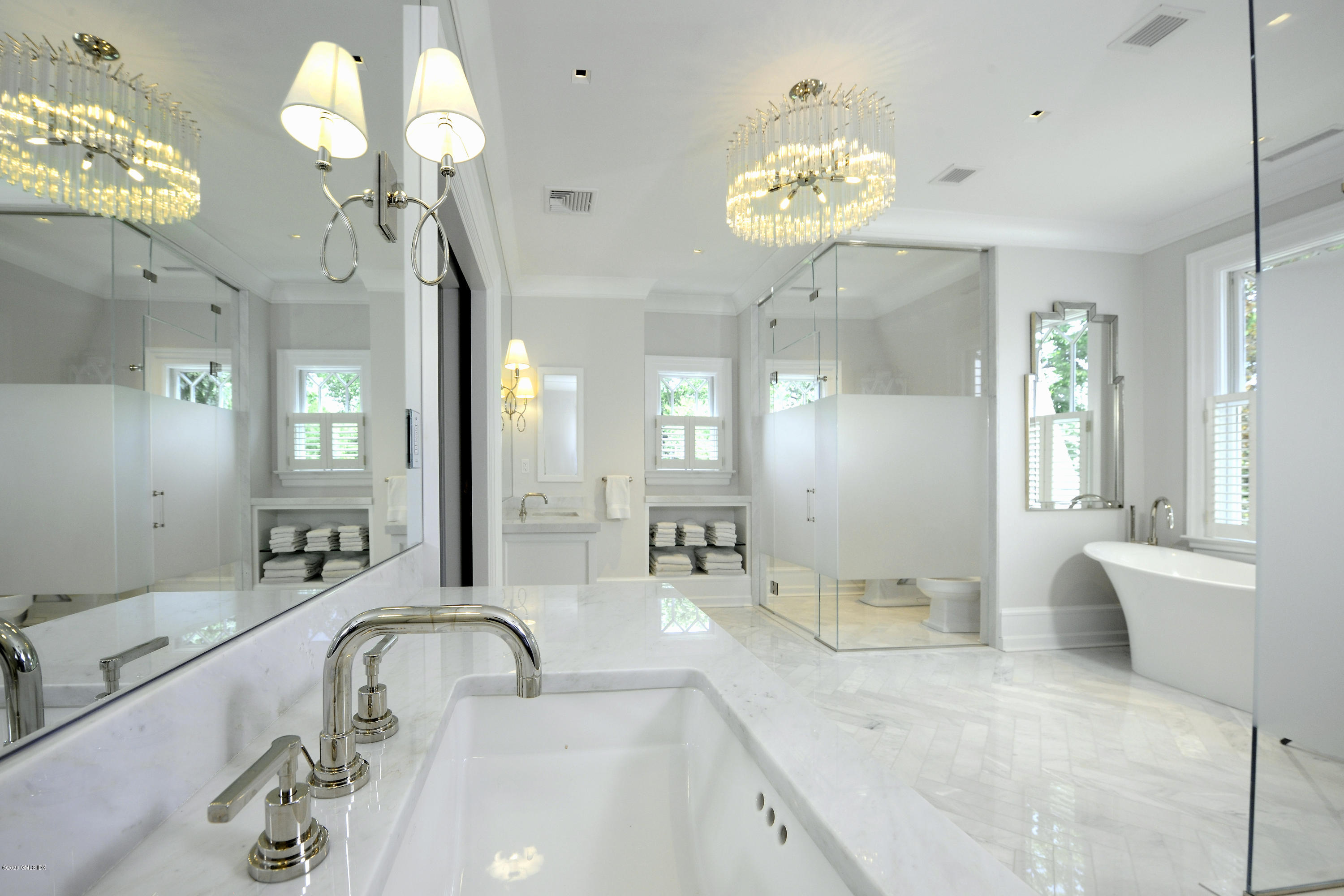 31 Rock Ridge Avenue Greenwich, CT 06831 - Photo 23 of 44 a bathroom with a sink a large mirror and a shower