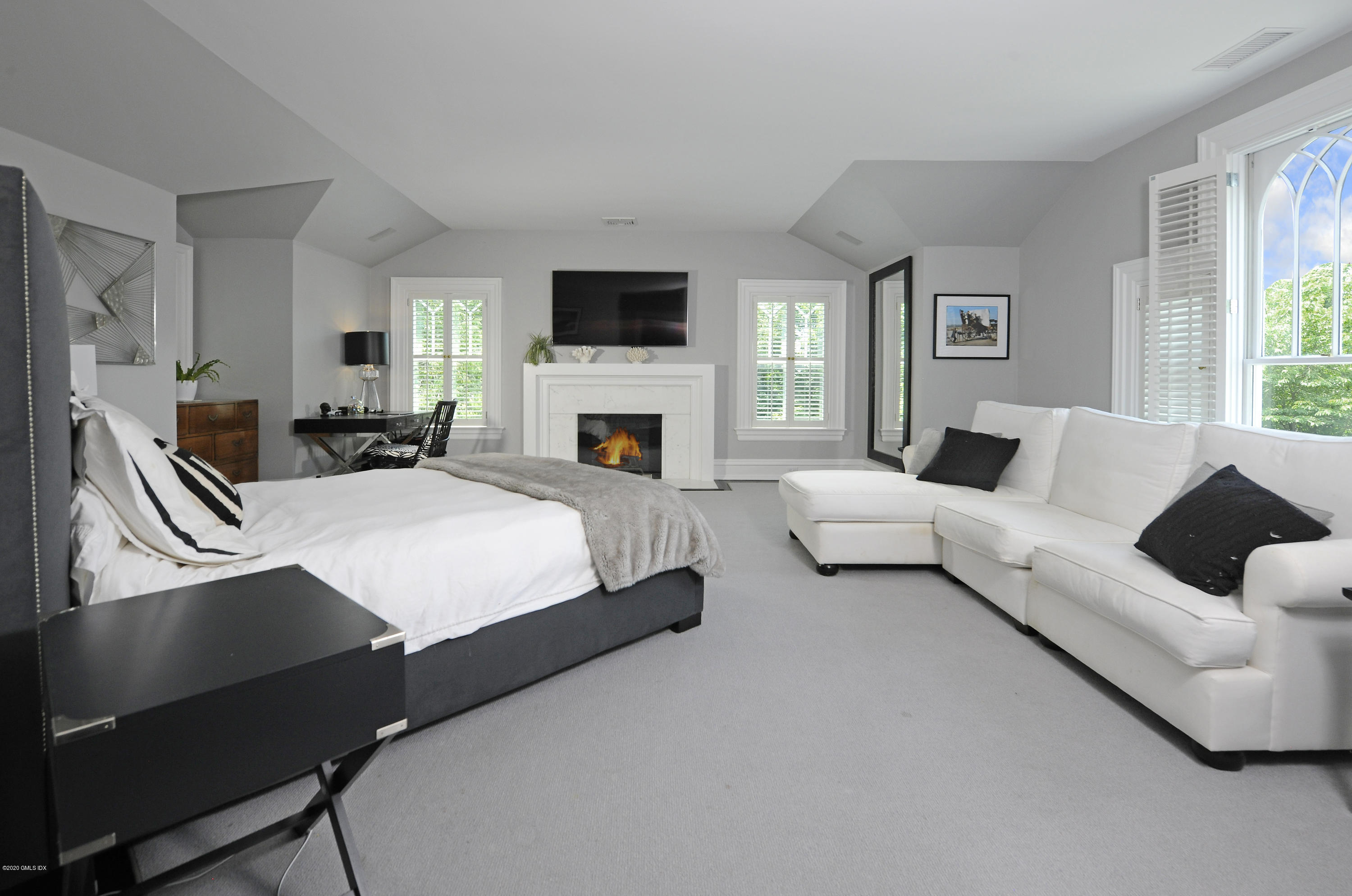 31 Rock Ridge Avenue Greenwich, CT 06831 - Photo 31 of 44 a living room with furniture a fireplace and a flat screen tv