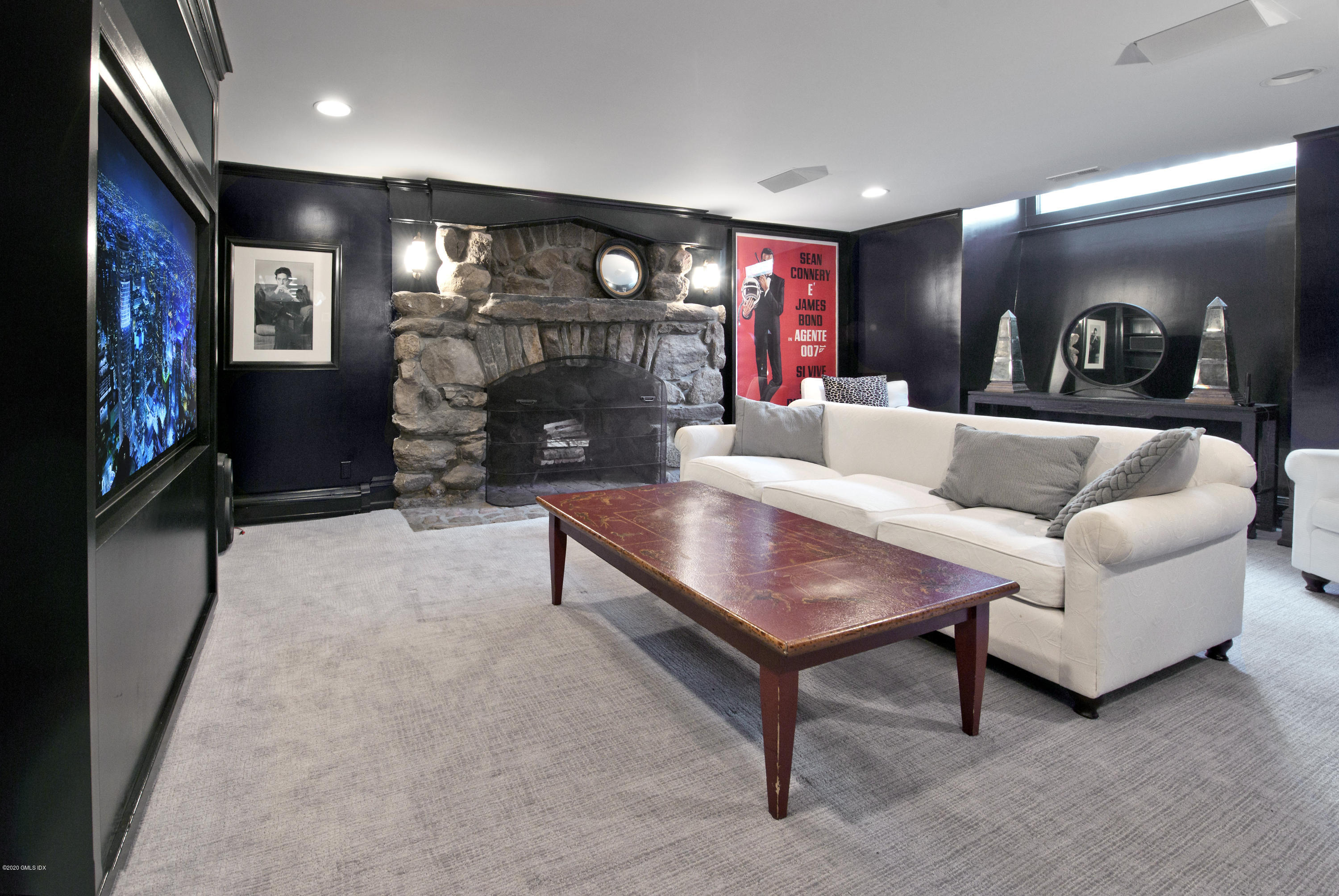 31 Rock Ridge Avenue Greenwich, CT 06831 - Photo 34 of 44 a living room with fireplace furniture and a flat screen tv