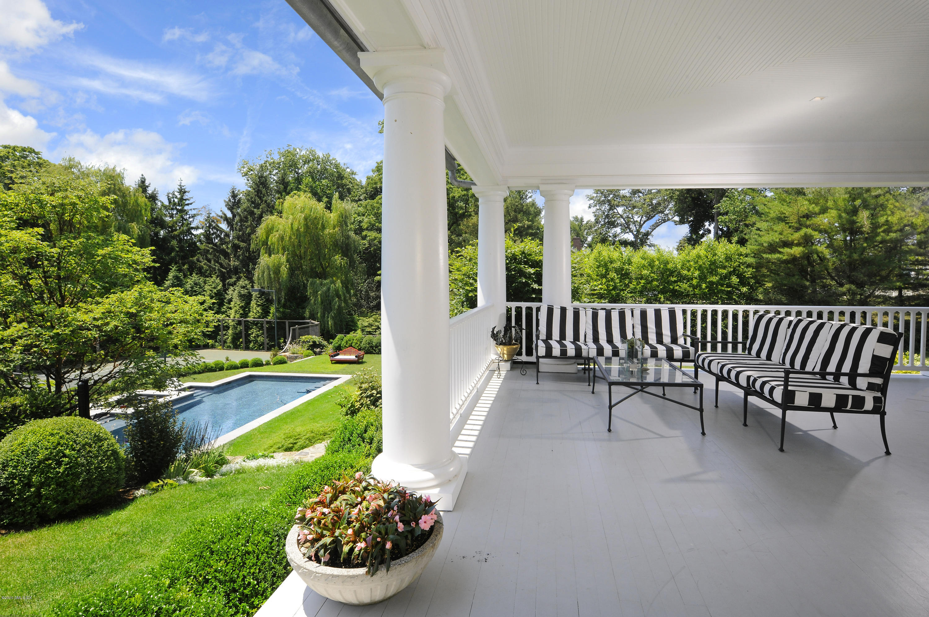 31 Rock Ridge Avenue Greenwich, CT 06831 - Photo 37 of 44 a view of a patio with a table and chairs and a yard