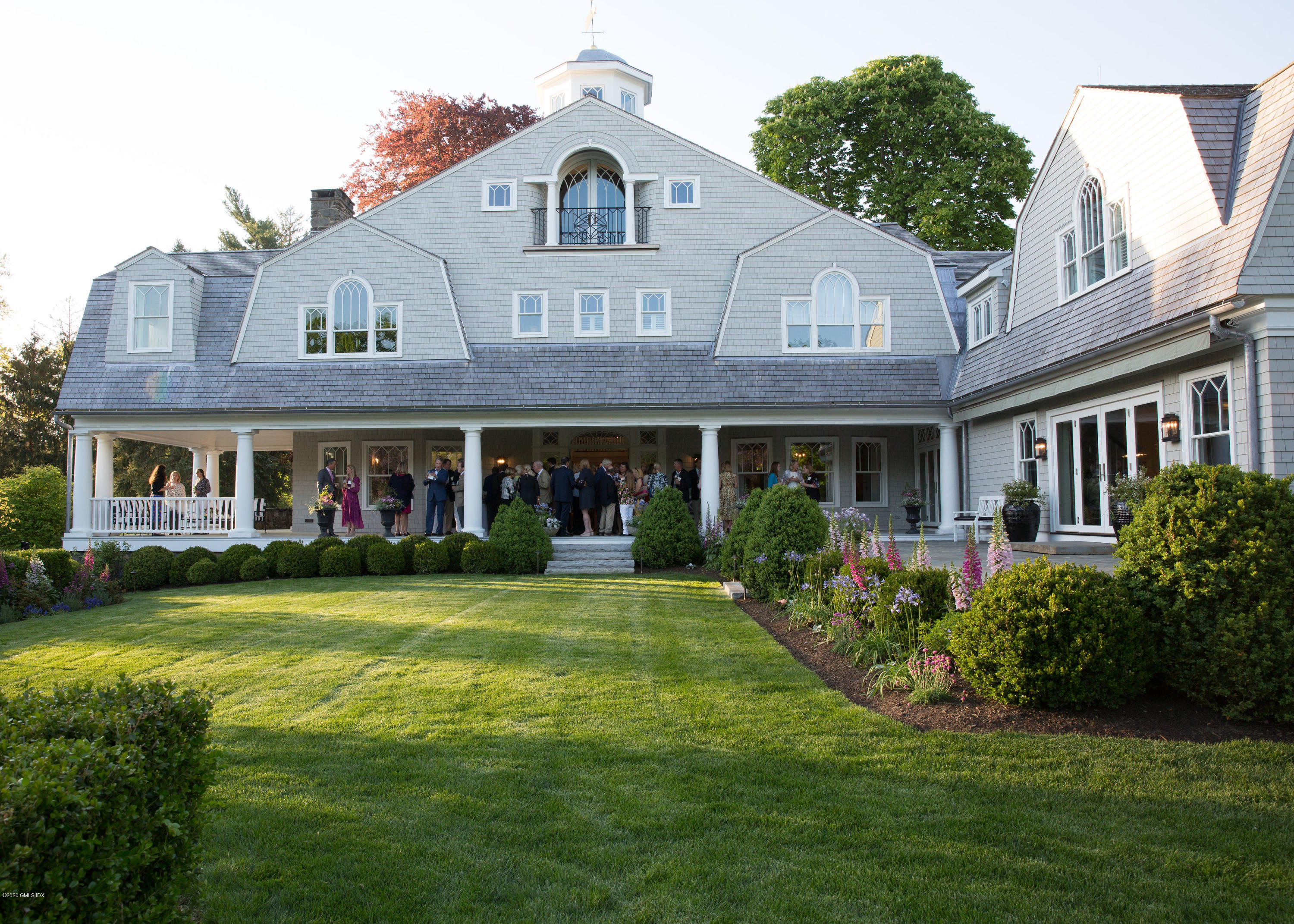 31 Rock Ridge Avenue Greenwich, CT 06831 - Photo 40 of 44 a view of a white house with a big yard and potted plants